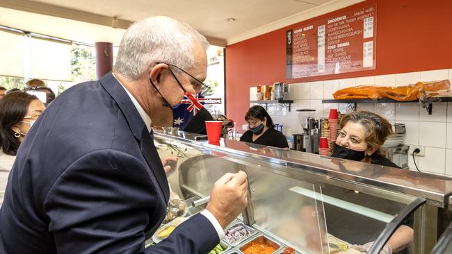 The PM orders a sandwich in a cafe in Box Hill. Picture: David Geraghty