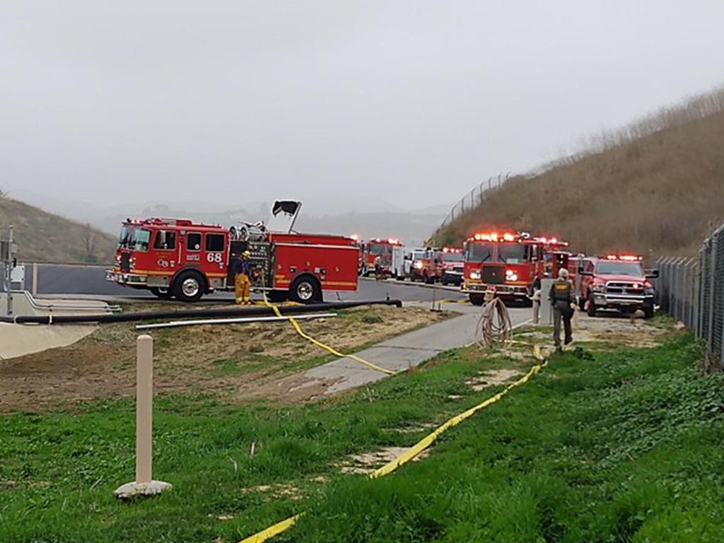 Fire crews attend the scene of the scene of helicopter crash in Calabasas. Picture: LA County Sheriff/Twitter.