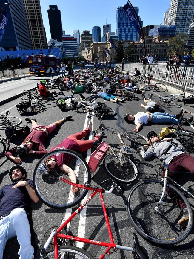 Cyclists lie down on the road during a mass protest ‘die-in’ on the Victoria Bridge in Brisbane in July 2017. There is another ‘die-in’ being planned for Wednesday. Picture: AAP Image/Darren England