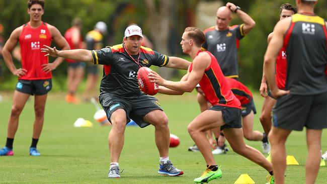 New Gold Coast coach Stuart Dew gets involved at training.