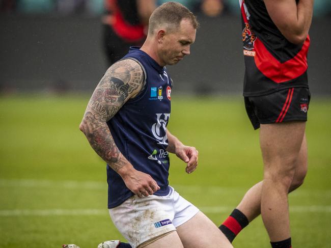 Launceston playing coach Mitch Thorp drops to his knees at the final siren after his team beat North Launceston. Picture: LUKE BOWDEN