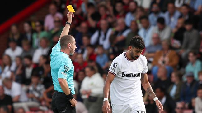 BOURNEMOUTH, ENGLAND - AUGUST 12: Referee Peter Bankes shows a yellow card to Lucas Paqueta of West Ham United during the Premier League match between AFC Bournemouth and West Ham United at Vitality Stadium on August 12, 2023 in Bournemouth, England. (Photo by Henry Browne/Getty Images)