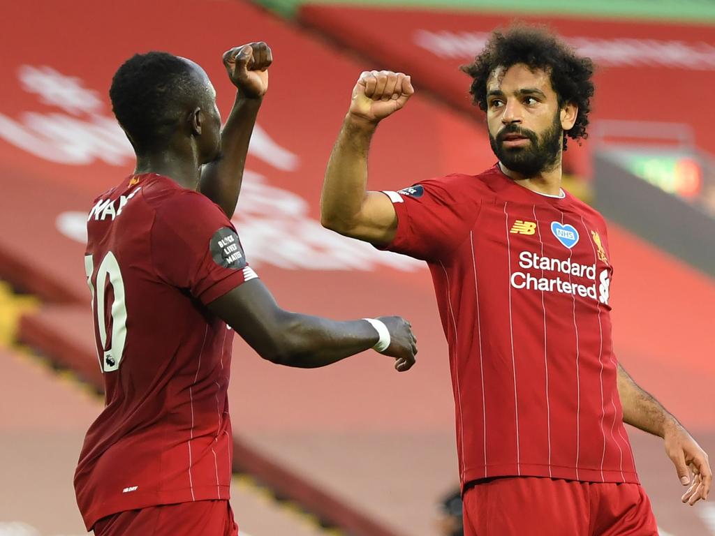 Mohamed Salah (right) celebrates scoring his team's second goal with Sadio Mane. (Photo by Shaun Botterill/AFP)