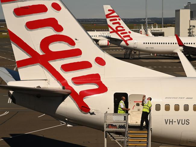 Virgin Australia planes are seen at Sydney airport on August 5, 2020. - Pandemic-struck airline Virgin Australia announced on August 5 it would close budget subsidiary Tigerair Australia and lay off 3,000 staff as it prepares to relaunch under new owners. (Photo by PETER PARKS / AFP)