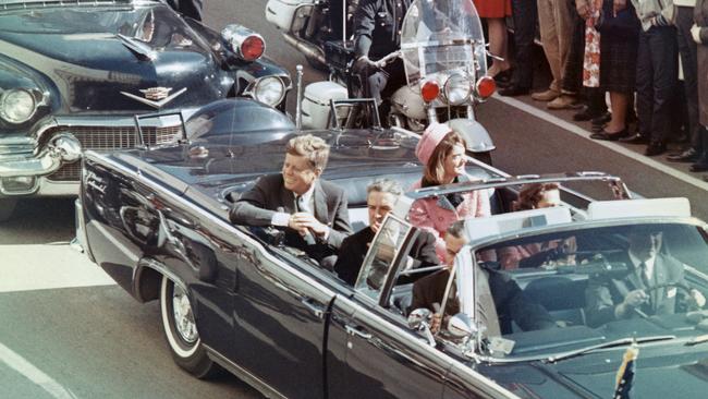 US President John F Kennedy, First Lady Jacqueline Kennedy, Texas Governor John Connally, and others smile at the crowds lining their motorcade route in Dallas, Texas, on November 22, 1963. Minutes later the President was assassinated as his car passed through Dealey Plaza.