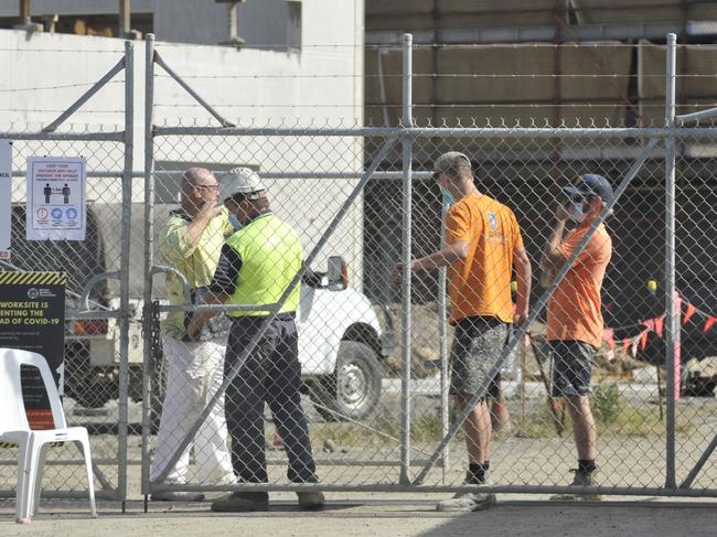 Tradies down tools at massive construction site after possible Covid link