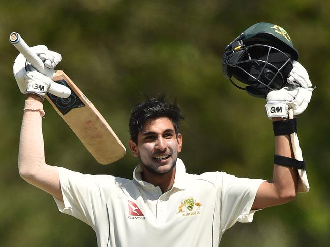 Australia XI's batsman Jason Sangha celebrates his century against England on the fourth and final day of the four-day Ashes tour match at the Tony Ireland Stadium in Townsville on November 18, 2017. / AFP PHOTO / Peter PARKS / -- IMAGE RESTRICTED TO EDITORIAL USE - STRICTLY NO COMMERCIAL USE --