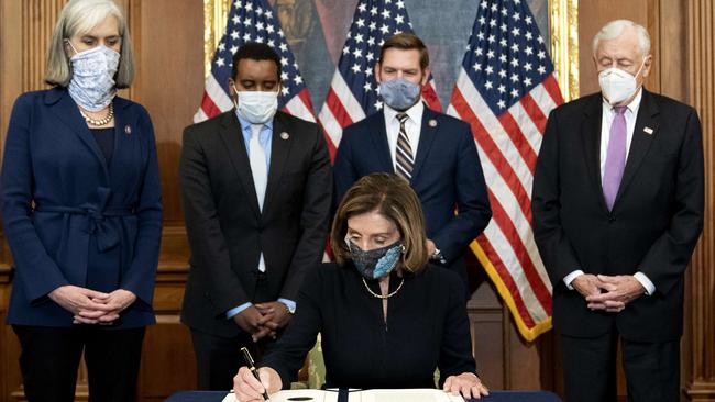 Nancy Pelosi signs an article of impeachment against President Donald Trump at the US. Capitol on January 13. Picture: Getty Images.