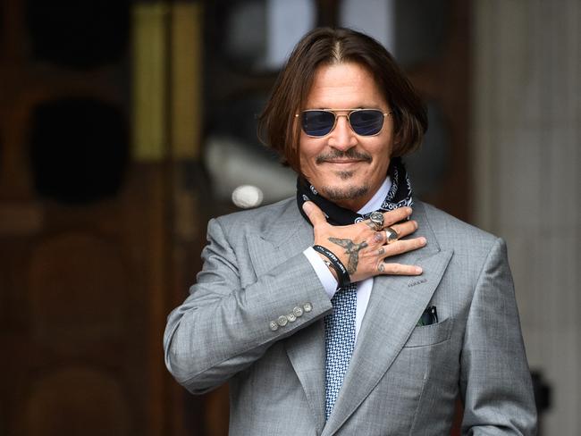 Johnny Depp posing outside court. Picture: Getty Images