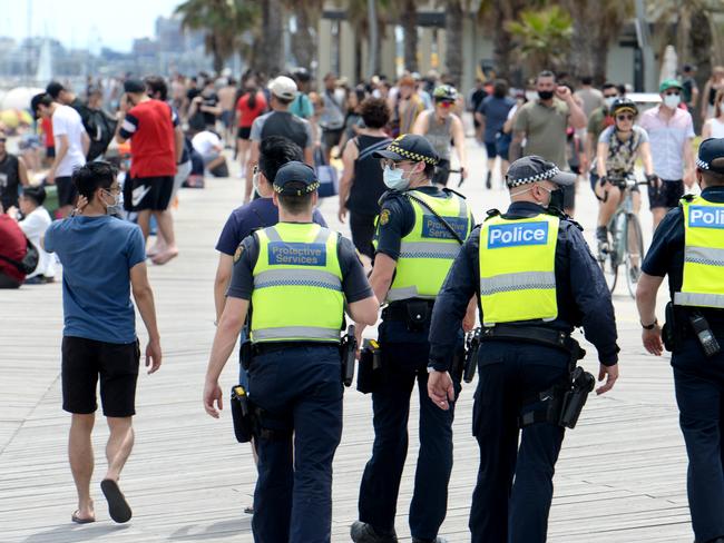 MELBOURNE, AUSTRALIA - NewsWire Photos NOVEMBER 3, 2020: Police and Protective Service Officers patrol as crowds flock to St Kilda Beach on the Melbourne Cup public holiday to soak up the sun. Picture: NCA NewsWire / Andrew Henshaw