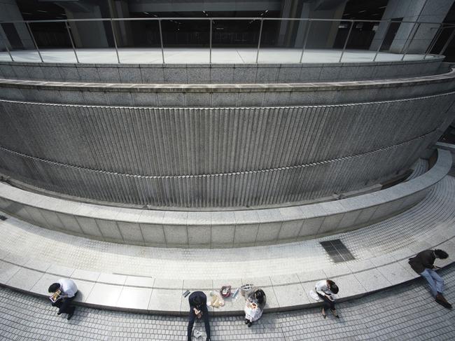 People have their lunch at regular intervals at Tokyo's Shinjuku district in Tokyo. Picture: AP