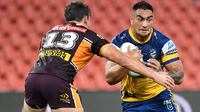 Marata Niukore (right) of the Eels is tackled by Patrick Carrigan (left) of the Broncos during the Round 3 NRL match between the Brisbane Broncos and the Parramatta Eels on Thursday night. Picture: AAP Image/Darren England