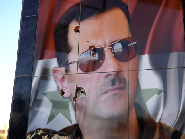 Abullet-riddled portrait of Syrian president Bashar al-Assad at the Kweyris military airfield in the eastern part of Aleppo province. Picture: Rami al Sayed / AFP