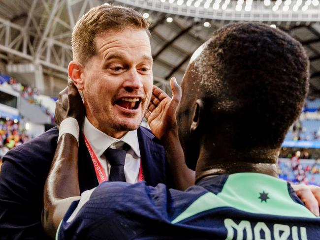 Paddy Steinfort celebrates with Socceroos star Awer Mabil at the FIFA World Cup in Qatar.