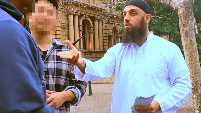 Abu Ousayd, centre, outside Sydney’s Town Hall. Police have said his latest sermon and language don’t constitute a criminal offence.