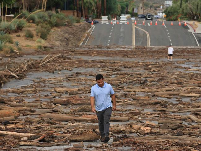 A worker from the Coachella Valley Water Department surveys the debris flow that has cut off Palm Springs. Picture: AFP