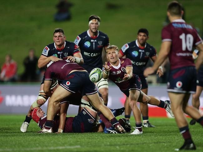 Reds halfback Tate McDermott throws a pass during his side’s 18-18 draw with the Rebels. Picture: Mark Metcalfe/Getty Images