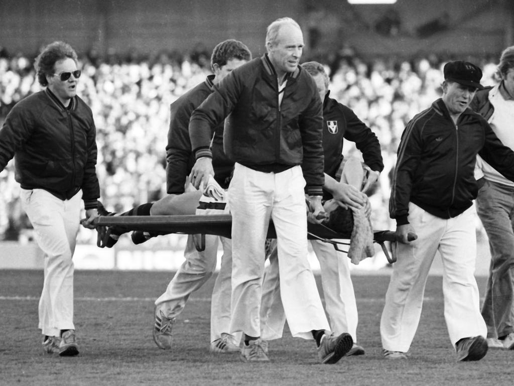 Paul Salmon is carried from the field after injuring his knee.