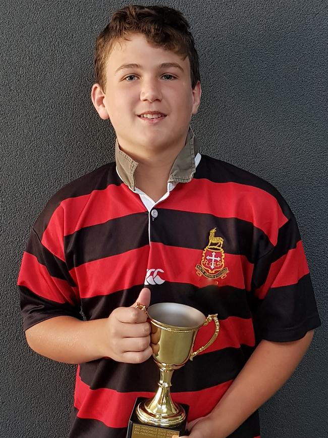 Rockhampton Grammar Primary rugby league team captain Tyson Carlos with the Jake Granville Cup.