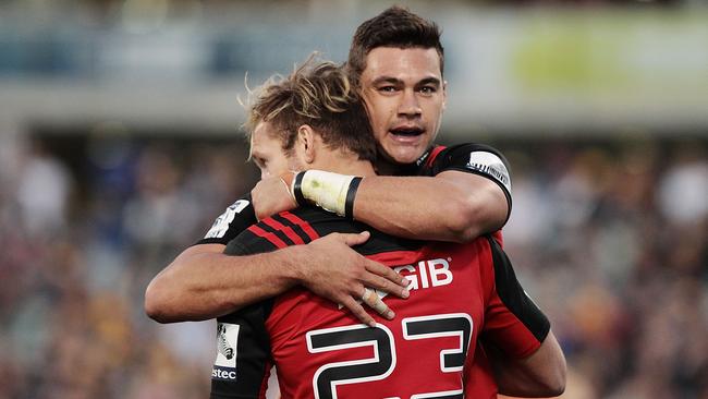 David Havili of the Crusaders congratulates Marty McKenzie after he scored a try against the Brumbies.