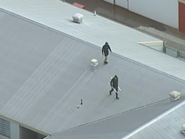 Police are currently on scene negotiating with three prisoners who have climbed on to the roof at Port Phillip Prison. Screen grabs from 7 news