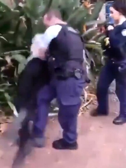 He is then filmed using a leg sweep to place him face-first on the ground. Source: Monica Kelly