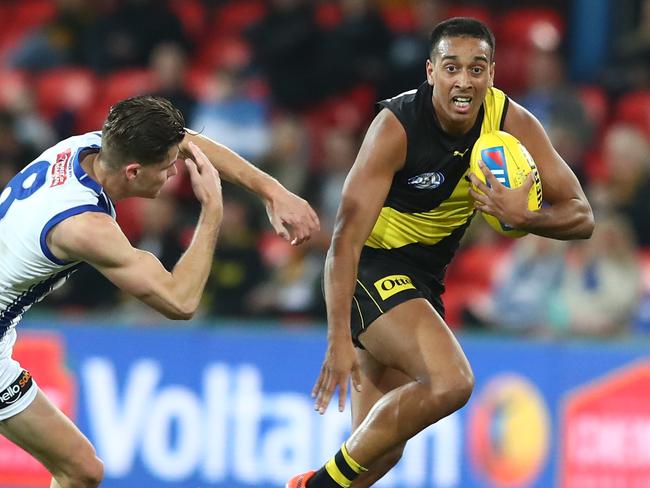 GOLD COAST, AUSTRALIA - JULY 18: Derek Eggmolesse-Smith of the Tigers runs the ball during the round 7 AFL match between the Richmond Tigers and the North Melbourne Kangaroos at Metricon Stadium on July 18, 2020 in Gold Coast, Australia. (Photo by Chris Hyde/Getty Images)