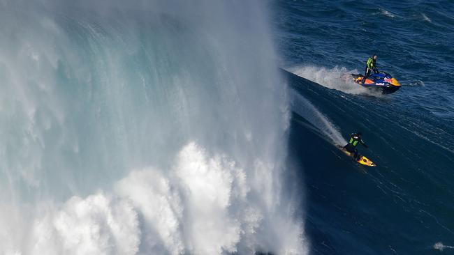 Surfers were riding huge waves at a surf competition in Portugal. Picture: AFP PHOTO / FRANCISCO LEONG