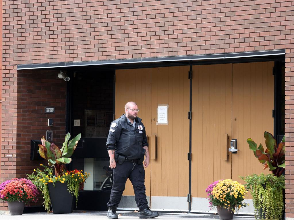 A security guard stands outside the front door of Machzikei Hadas Orthodox synagogue in Ottawa. Picture: AFP