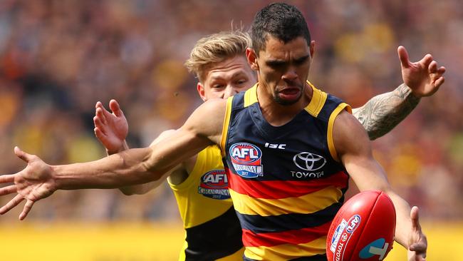 Charlie Cameron makes a break under hot pursuit. Picture: Cameron Spencer/AFL Media/Getty Images