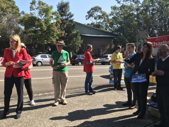 Lucy Wicks and Anne Charlton handing out how to votes at Erina High School yesterday.