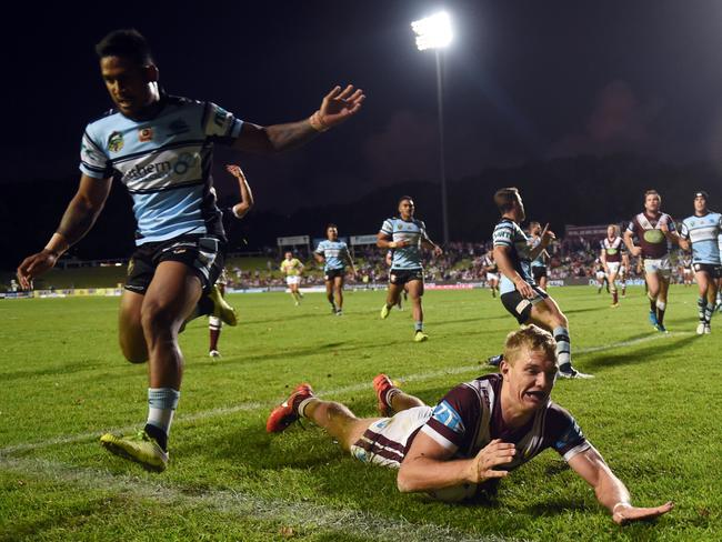 Tom Trbojevic (centre) of the Sea Eagles scores a try that was later disallowed during the round 3 NRL match between the Manly Sea Eagles and the Cronulla Sutherland Sharks at Brookvale Oval in Sydney on Monday, March 21, 2016. (AAP Image/Paul Miller) NO ARCHIVING, EDITORIAL USE ONLY