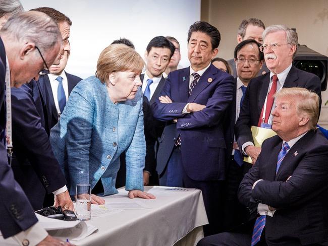 TOPSHOT - Photo released on Twitter by the German Government’s spokesman Steffen Seibert on June 9, 2018 and taken by the German government's photographer Jesco Denzel shows US President Donald Trump (R) talking with German Chancellor Angela Merkel (C) and surrounded by other G7 leaders during a meeting of the G7 Summit in La Malbaie, Quebec, Canada. The photo went viral, popping up all over social media, sometimes in its original form sometimes altered for humorous or satirical ends. / AFP PHOTO / Bundesregierung / Jesco DENZEL / RESTRICTED TO EDITORIAL USE - MANDATORY CREDIT 