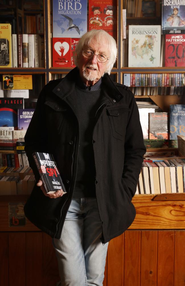 Author Douglas Lockhart holding a copy of his 8th novel, An Imperfect Spy. Picture: Nikki Davis-Jones