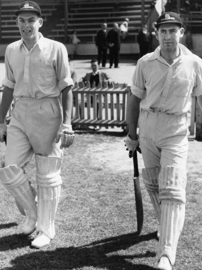 Four-Test batsman and Saints opener Gavin Stevens, pictured (left) walking out to the crease with Ron Haddrick (right) for Glenelg’s clash with Kensington in 1953. 