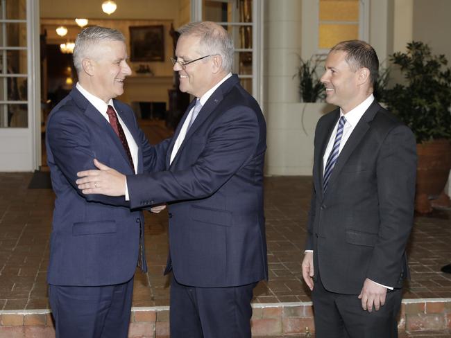 Deputy Prime Minister and Nationals leader Michael McCormack greets Mr Morrison and Mr Frydenberg at Government House. Picture: Sean Davey