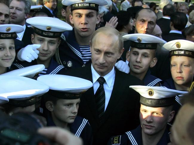 Vladimir Putin meets with students of a naval boarding school while attending the unveiling of a monument to late Anatoly Sobchak, St. Petersburg's liberal Mayor, in St. Petersburg, Russia, 2006.