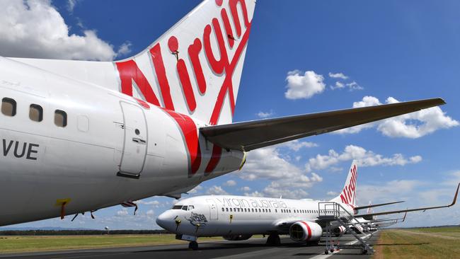 Grounded Virgin Australia aircraft are seen parked at Brisbane Airport in Brisbane. Picture: AAP