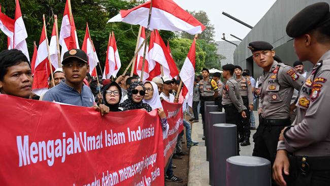 Indonesian policemen stand guard as protesters hold a rally outside the Australian embassy in Jakarta against the plan to move Australian embassy in Israel from Tel Aviv to Jerusalem. Picture: AFP 