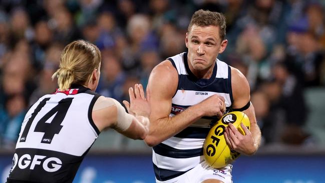 ADELAIDE, AUSTRALIA – JUNE 10: Miles Bergman of the Power tackles Joel Selwood of the Cats during the 2021 AFL Round 13 match between the Port Adelaide Power and the Geelong Cats at Adelaide Oval on June 10, 2021 in Adelaide, Australia. (Photo by James Elsby/AFL Photos via Getty Images)