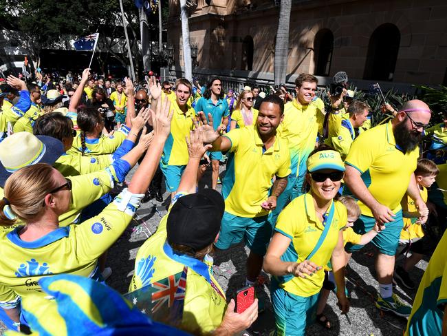 Commonwealth Games athletes are applauded as they make their way throught the street parade. Picture: Dan Peled/AAP