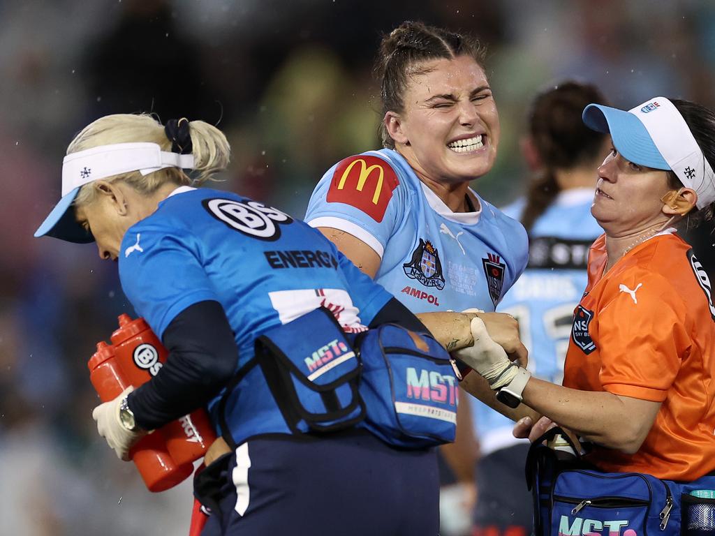 NEWCASTLE, AUSTRALIA – JUNE 06: Jessica Sergis of the Blues is attended to by trainers after an injury during game two of the Women's State of Origin series between New South Wales Sky Blues and Queensland Maroons at McDonald Jones Stadium on June 06, 2024 in Newcastle, Australia. (Photo by Cameron Spencer/Getty Images)