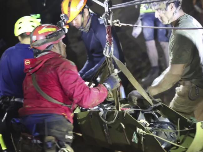 Rescuers hold an evacuated boy inside the Tham Luang Nang Non cave in Mae Sai. Picture: Thai NavySEAL Facebook Page via AP