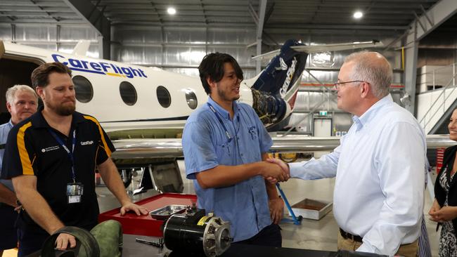 Mr Morrison meets air technicians during a visit to CareFlight’s Darwin hangar, which is in the electorate of Solomon. (Photo by Asanka Ratnayake/Getty Images)