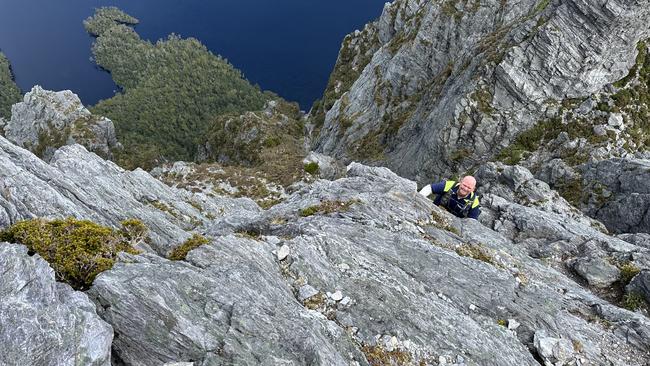 Senior Constable Callum Herbert from Police Search and Rescue on the summit climb to Federation Peak during a recent mission.