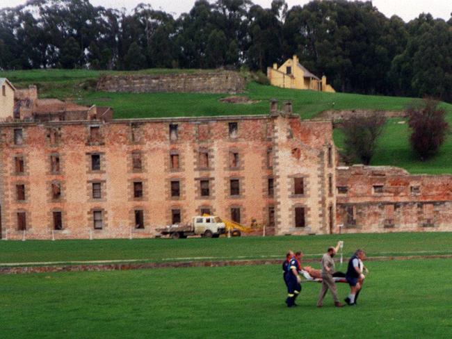 A shooting victim is carried to a helicopter at Port Arthur.