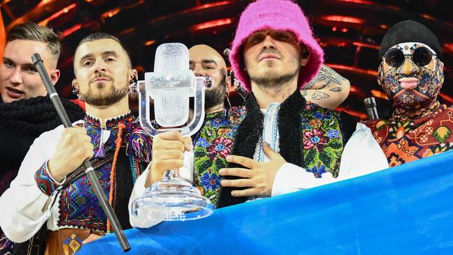 Members of the band "Kalush Orchestra" pose onstage with the winner's trophy and Ukraine's flags after winning the Eurovision Song contest 2022. Picture: AFP.