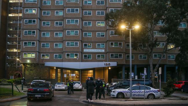 Police at the front of a housing commission tower in the Melbourne suburb of Flemington, where a coronavirus outbreak has been recorded and lockdowns have begun. Picture: Getty Images