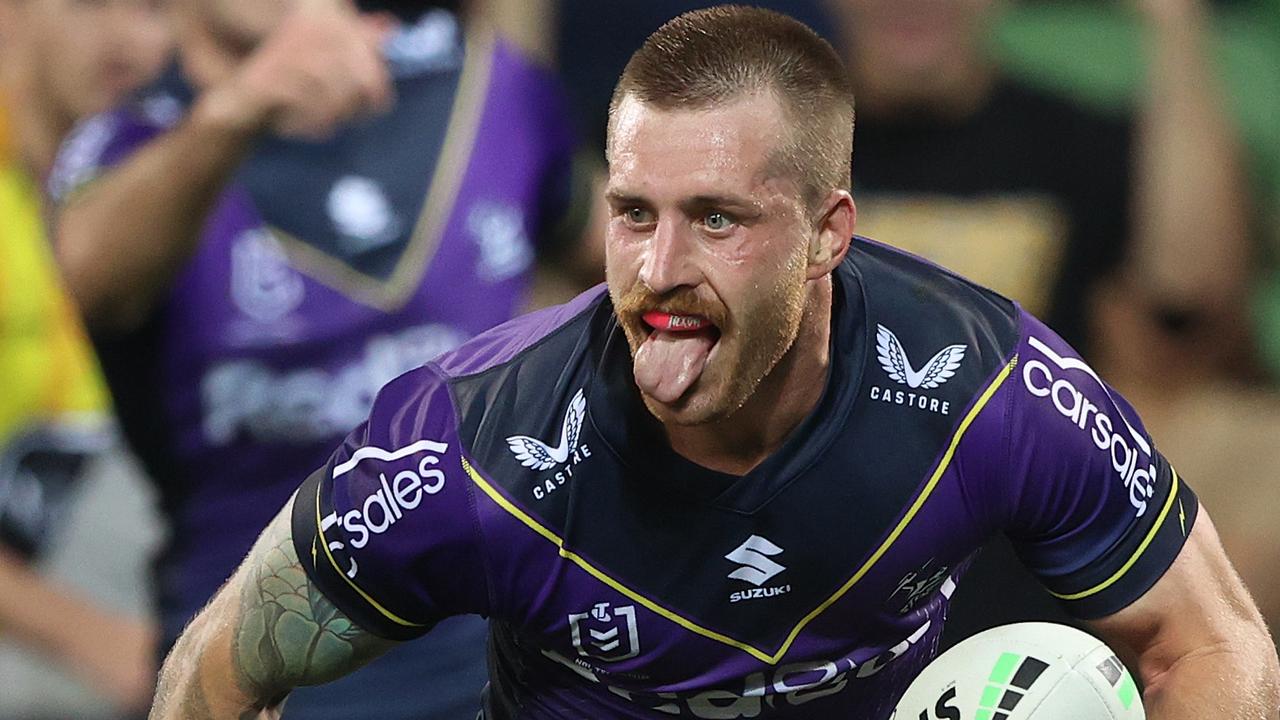 MELBOURNE, AUSTRALIA - APRIL 16: Cameron Munster of the Storm celebrates on his way to scoring a try during the round six NRL match between the Melbourne Storm and the Cronulla Sharks at AAMI Park, on April 16, 2022, in Melbourne, Australia. (Photo by Robert Cianflone/Getty Images)