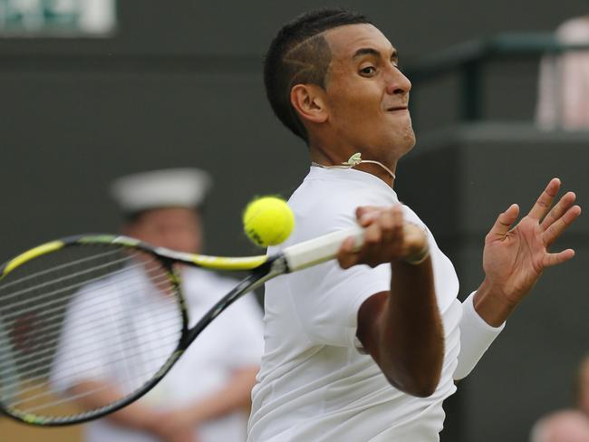 Nick Kyrgios returns a shot against Milos Raonic in the Wimbledon quarter-final.